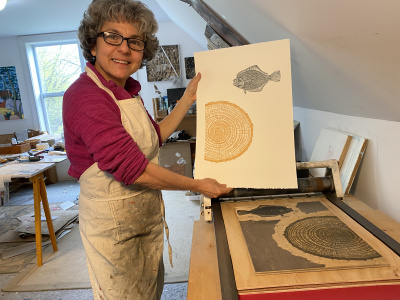 Gloria showing one of her paintings