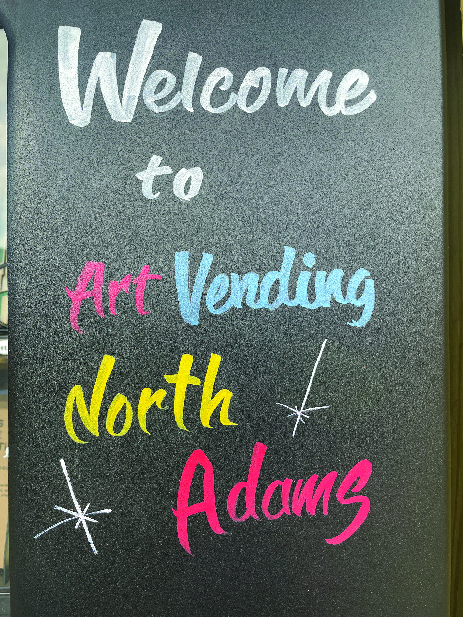 Artist Aaron Oster painted the front of Art Vending North Adams in his signature traditional sign painting technique.